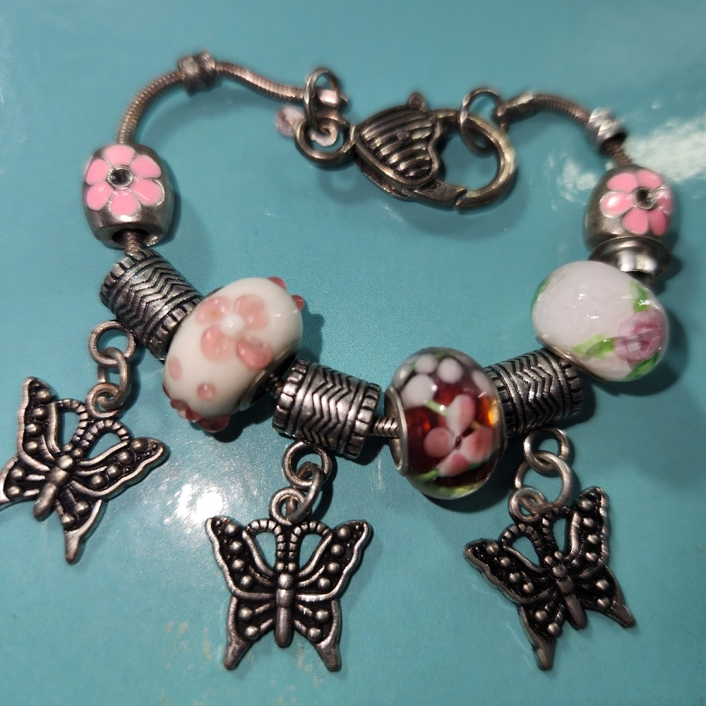 #2572,  RMN ROMAN CO.  BRACELET BUTTERFLY CHARM, PINK FLORAL GLASS BEADS.